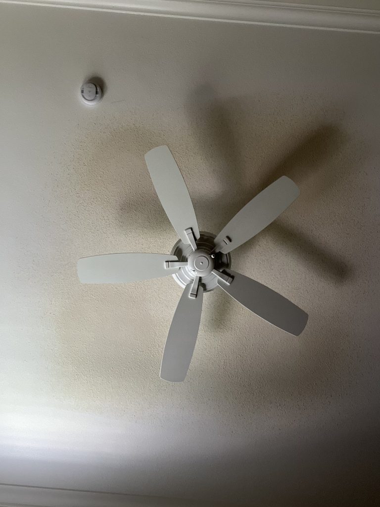 Water-stained orange-peel textured ceiling before repair
