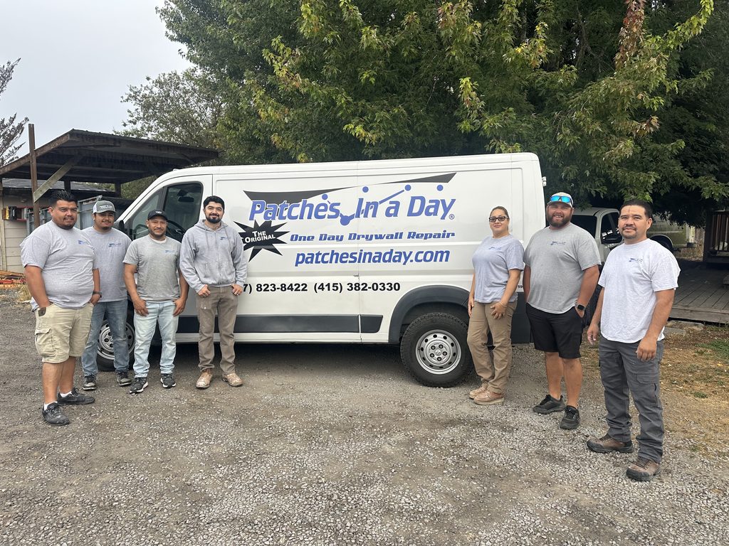 The Patches In A Day crew standing in front of a branded company van